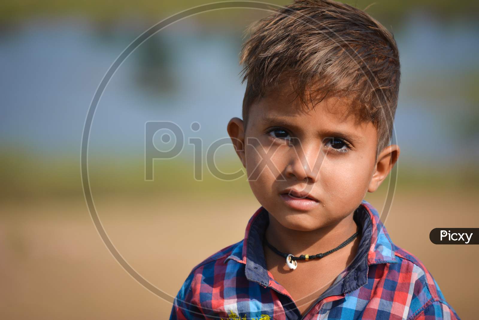 TIKAMGARH, MADHYA PRADESH, INDIA - NOVEMBER 20, 2019: Happy little indian boy with expression in outdoor.
