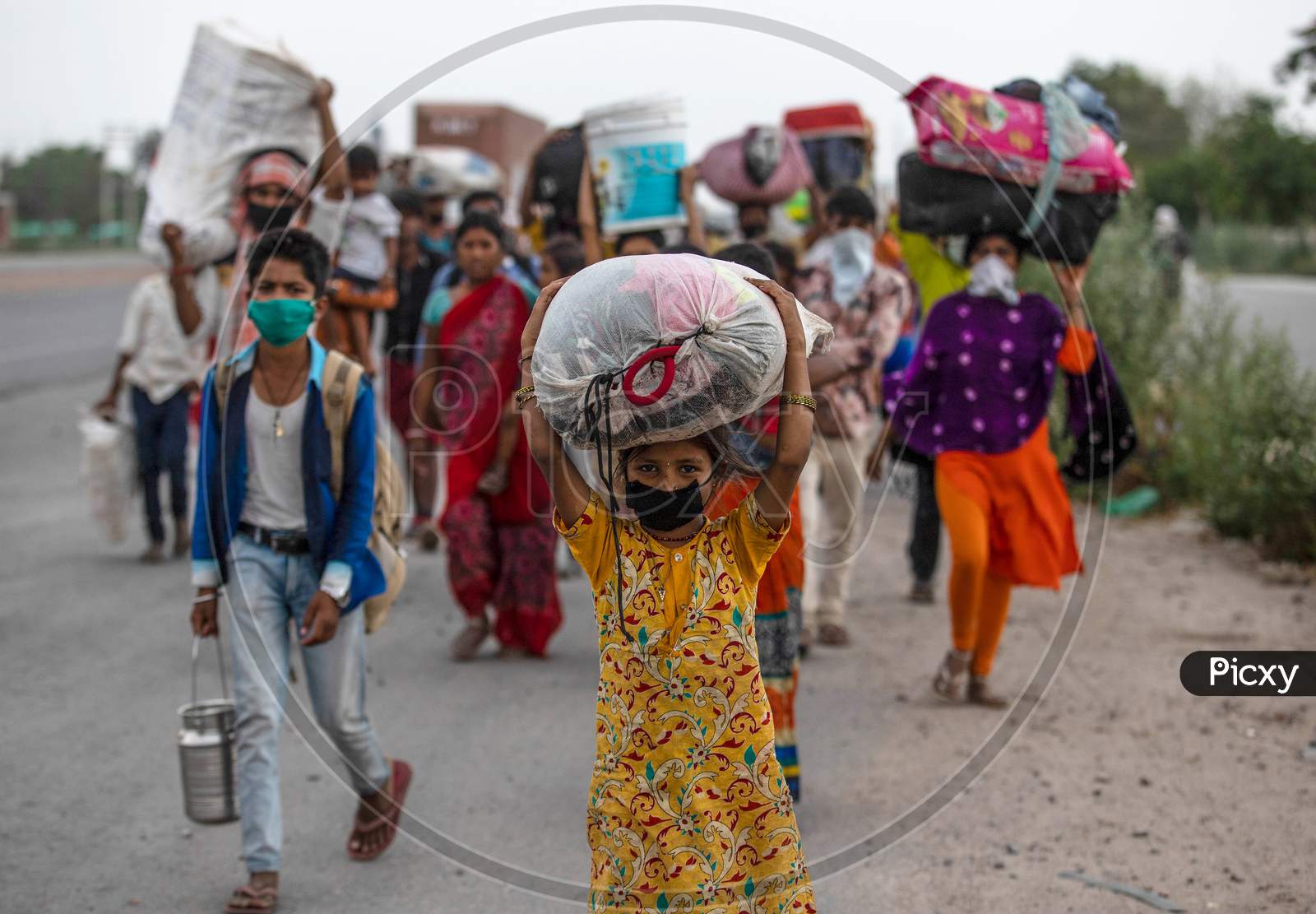 Sapna, 8, A Daughter Of Migrant Worker, Walks Along A Highway With Her Family To Return To Their Village In Purnia District Of Bihar During An Extended Nationwide Lockdown To Slow The Spread Of The Coronavirus Disease, In Sonipat, Haryana On May 19,2020.
