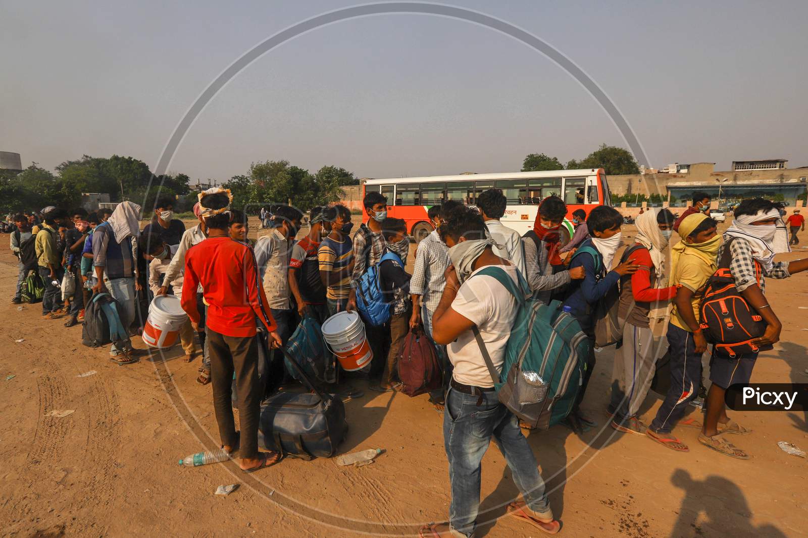 Migrant Workers Waiting To  Board A Bus, After The Government Eased A Nationwide Lockdown, At Gaziabad, On May 18, 2020 In New Delhi, India.