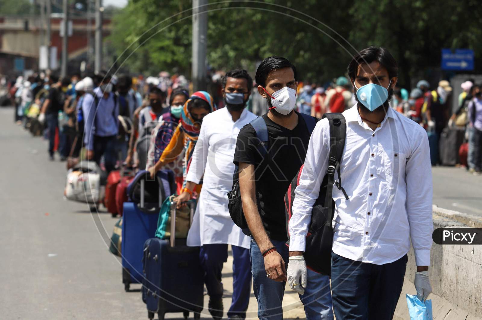 Image of People Wait In A Queue Outside The Railway Station To Board ...