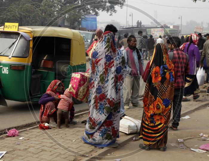 People waiting on the streets in Delhi