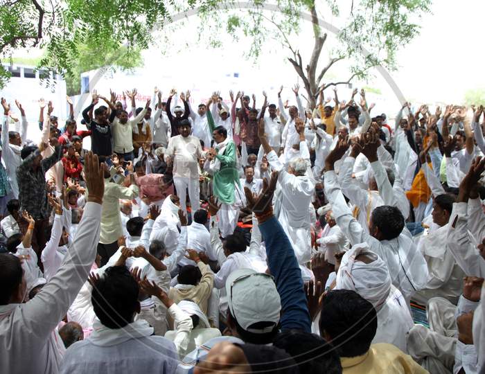 Group of People Under a tree with Hands Raised up