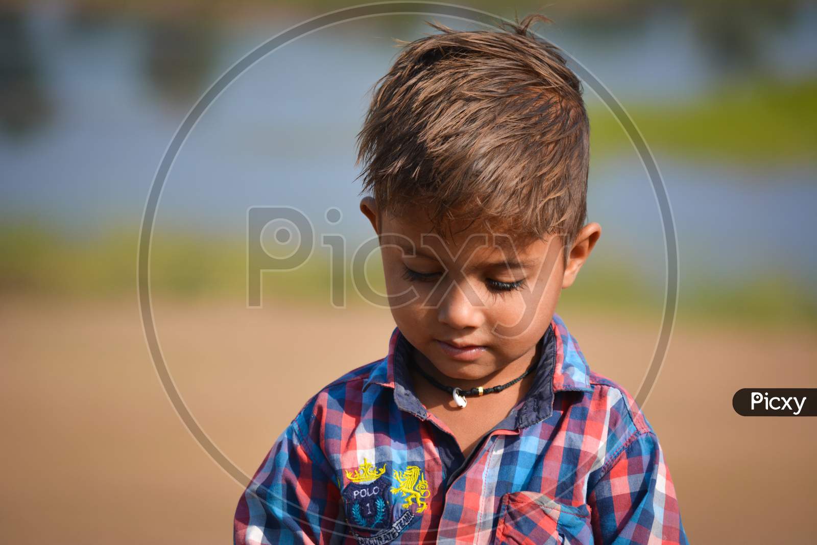 TIKAMGARH, MADHYA PRADESH, INDIA - NOVEMBER 20, 2019: Happy little indian boy with expression in outdoor.