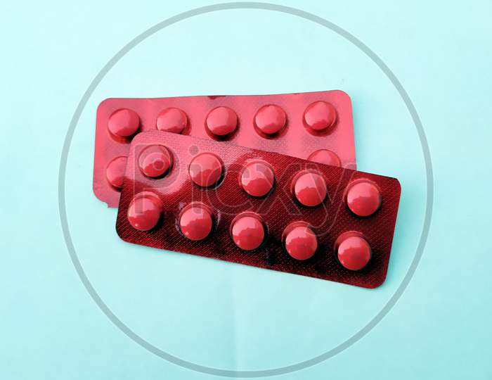 red medicine tablet isolated on white background