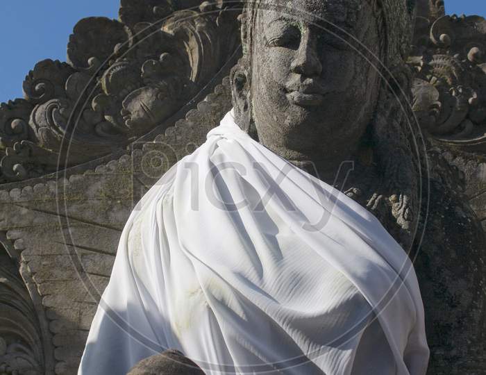 Stone Buddha Statue Dressed With White Rope