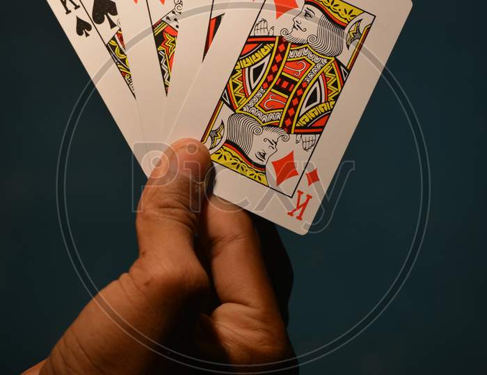 TIKAMGARH, MADHYA PRADESH, INDIA - DECEMBER 15, 2019: Hand holding all kings of playing card.
