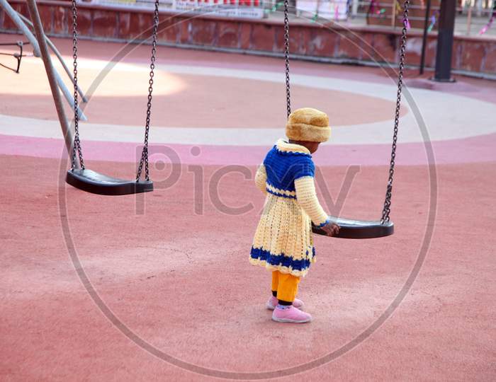 A Kid near a swing
