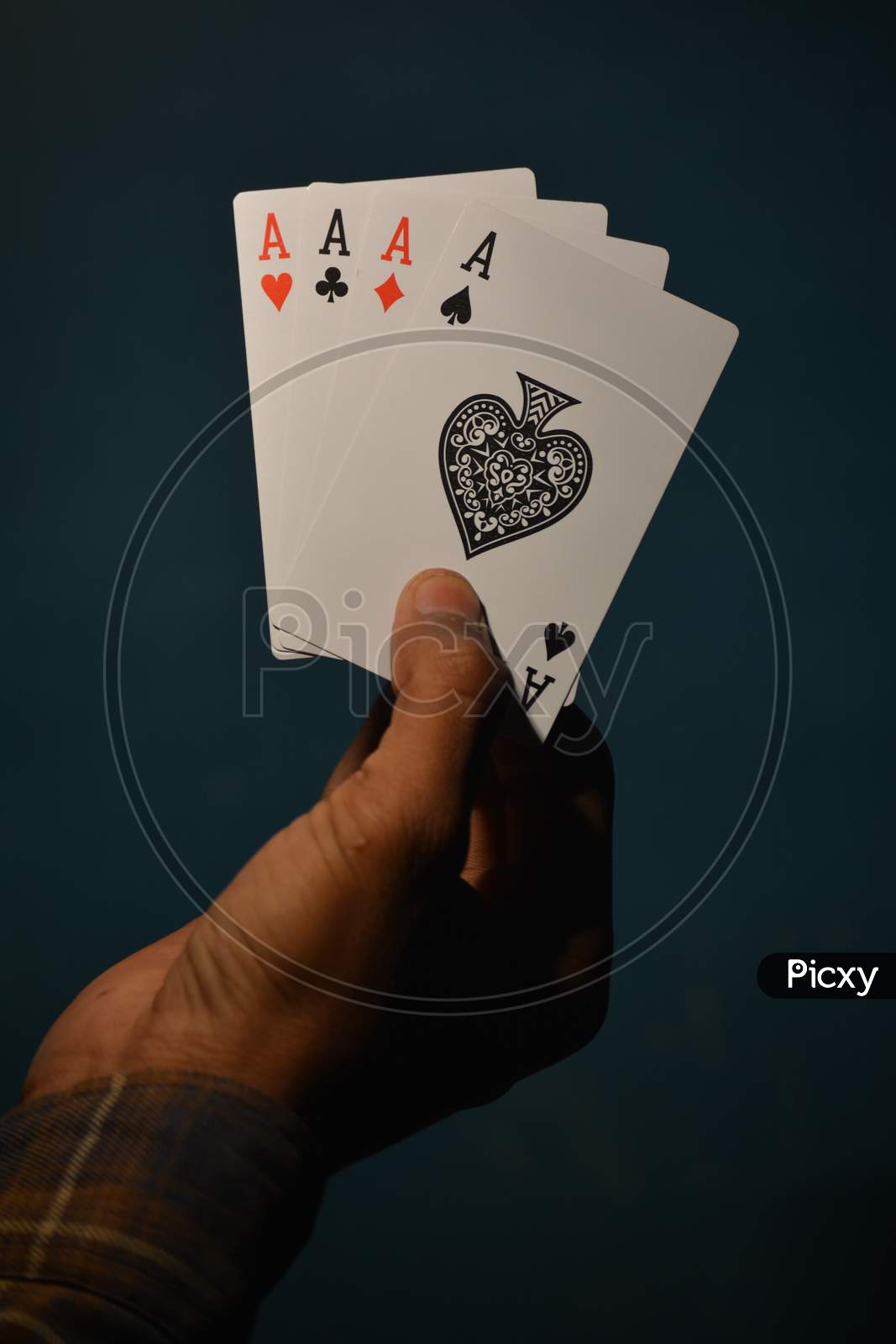 TIKAMGARH, MADHYA PRADESH, INDIA - DECEMBER 15, 2019: Hand holding four aces playing cards, four of kind.