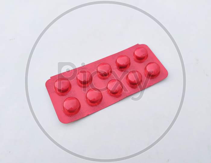 red medicine tablet isolated on white background