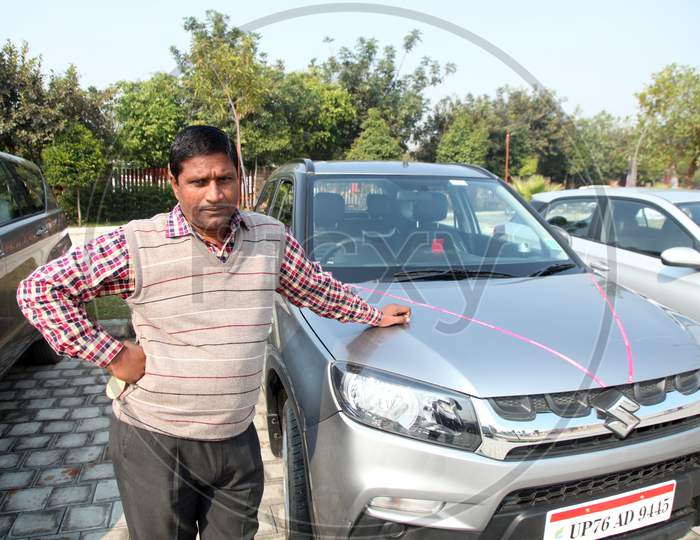 A Middle-Aged Indian man with a Car