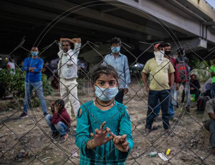 A Daughter Of Migrant Worker Wearing A Face Mask Waits To Cross The Border To Her Home State Of Bihar, During An Extended Nationwide Lockdown To Slow The Spread Of The Coronavirus Disease, In New Delhi, India, On May 16, 2020.