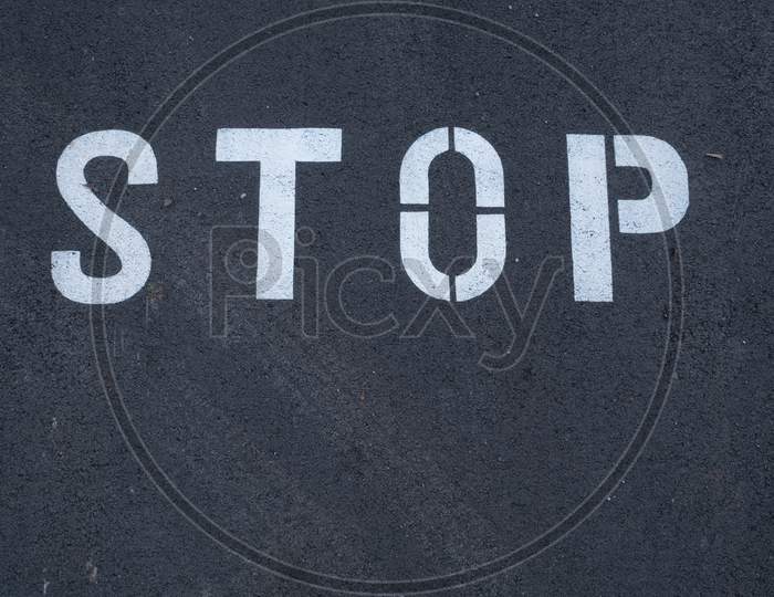 Stop Sign Painted On The Asphalt