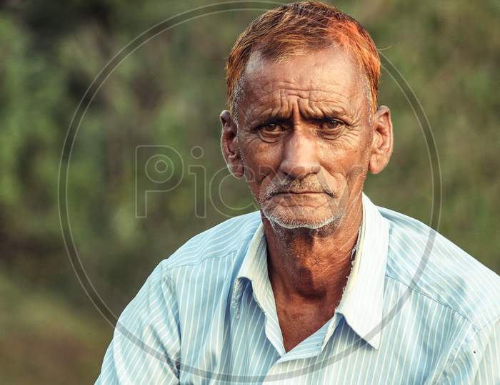 Almora, Uttrakhand, India- May 22 2020: A Travel Portrait Of An Old Person Looking Into The Camera, Wrinkles All Over The Face And Red Hair.