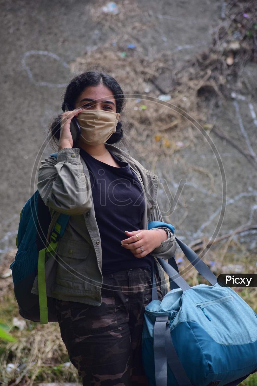Young woman with  backpack  wearing protection face mask against coronavirus 2019-nCoV