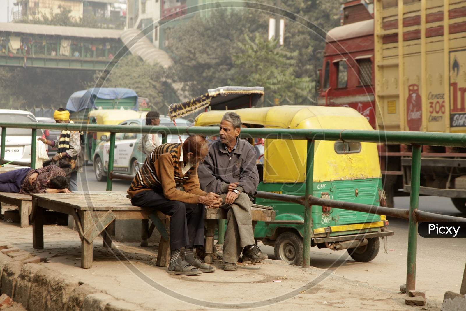 A couple of Old Men's sat alongside a Road