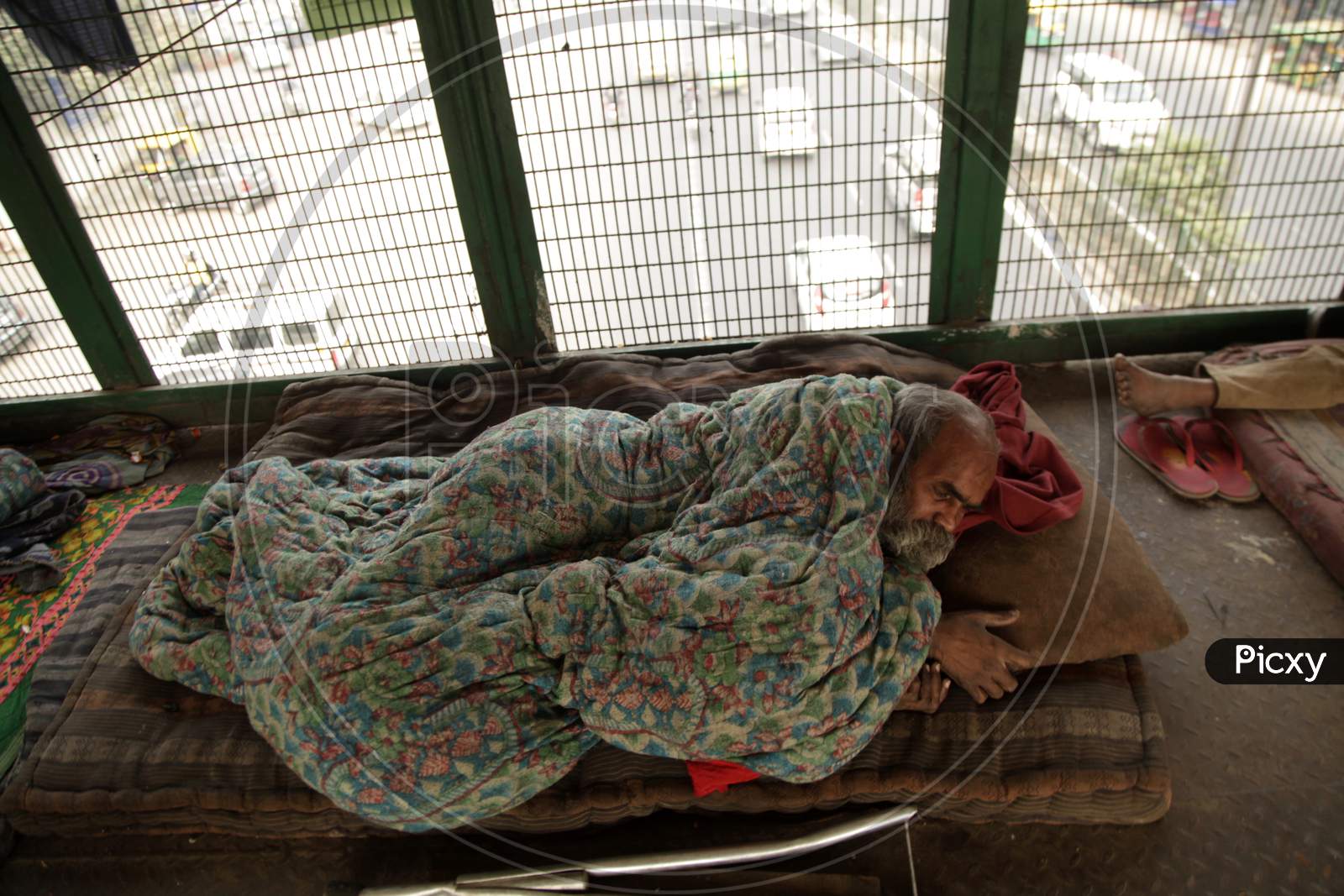 People sleeping on the Foot-over Bridge