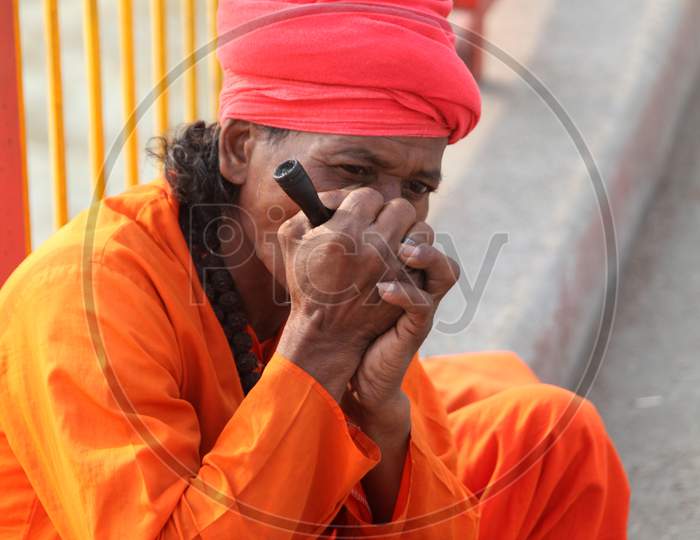 Portrait of an Old Indian Hindu Sadhu or Baba Smoking Chillam
