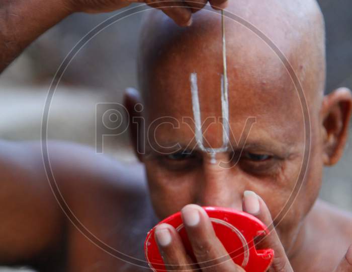 Portrait of a Middle-Aged Indian Man keeping Namam
