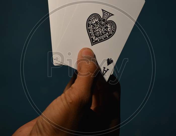 TIKAMGARH, MADHYA PRADESH, INDIA - DECEMBER 15, 2019: Hand holding four aces playing cards, four of kind.