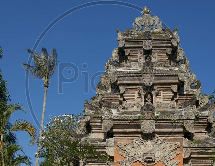 Low Angle View On The Upper Part Of The Beautiful Stone Gate Of Ubud Palace