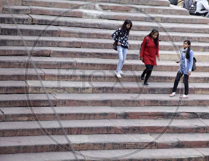 A couple of Young Girls walking on the steps