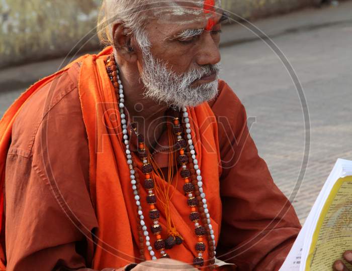 Portrait of an Old Indian Hindu Sadhu or Baba reading a Book