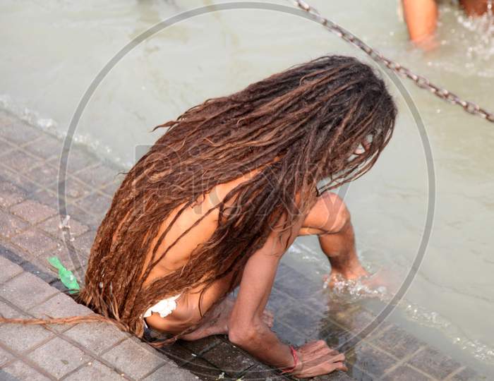 A Sadhu or Baba stepping to a river