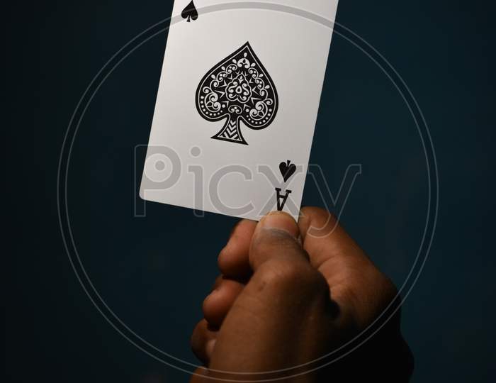TIKAMGARH, MADHYA PRADESH, INDIA - DECEMBER 15, 2019: Hand holding ace of spades playing card.