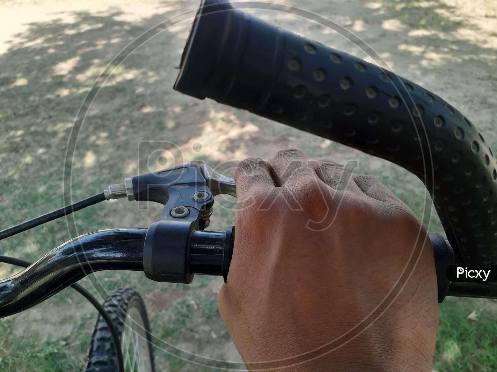 An Asian Person Is Holding Bicycle Steering And Its Brakes