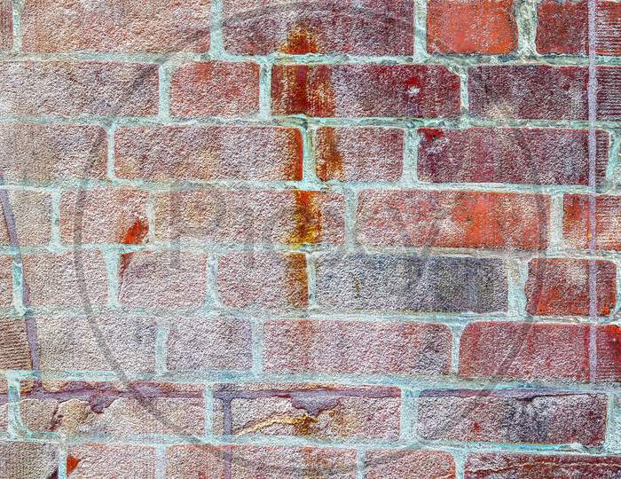 Detailed close up view on very old and weathered brick walls with cracks found in London