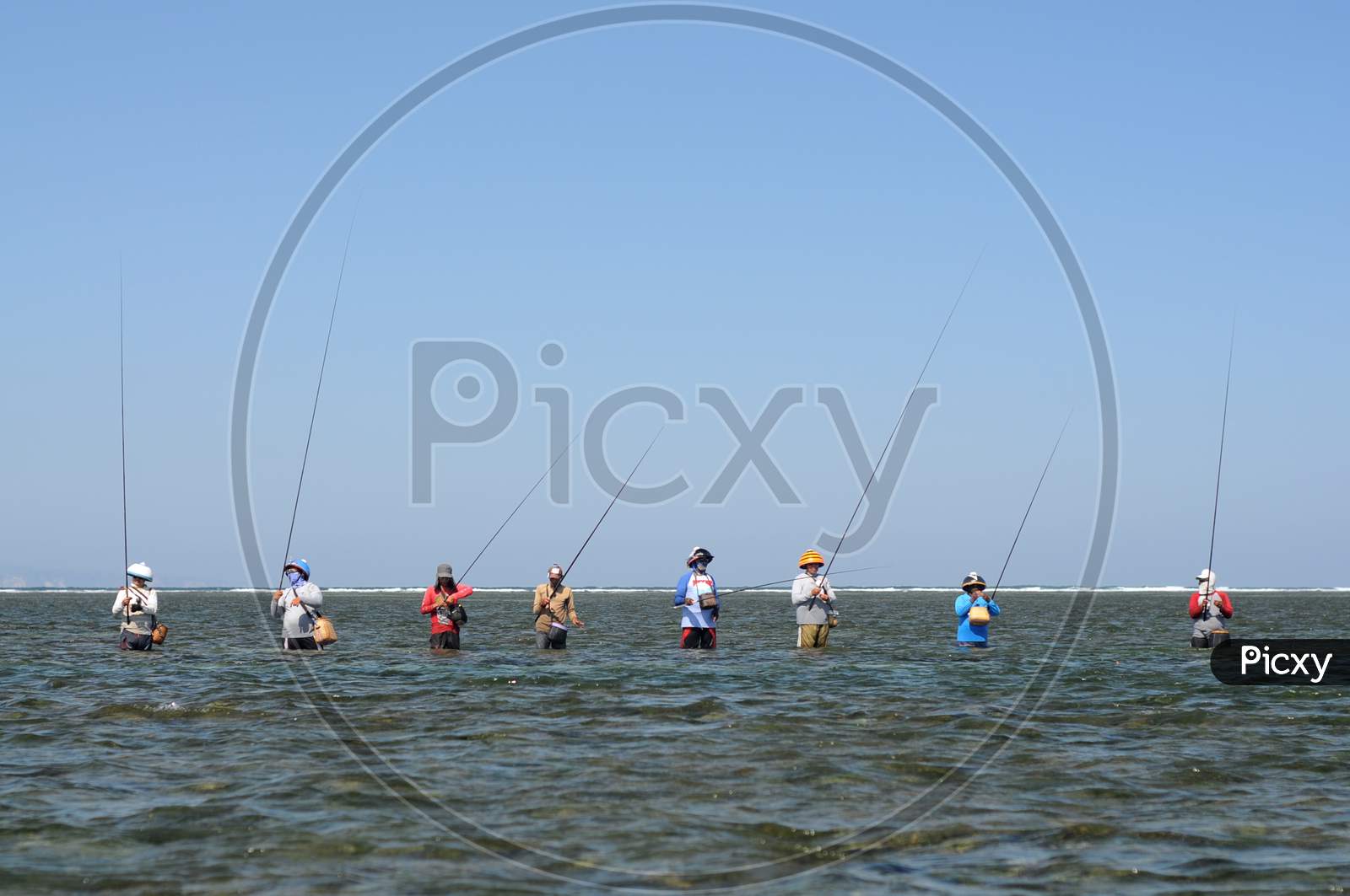 Typical Balinese Fishermen Standing In A Row