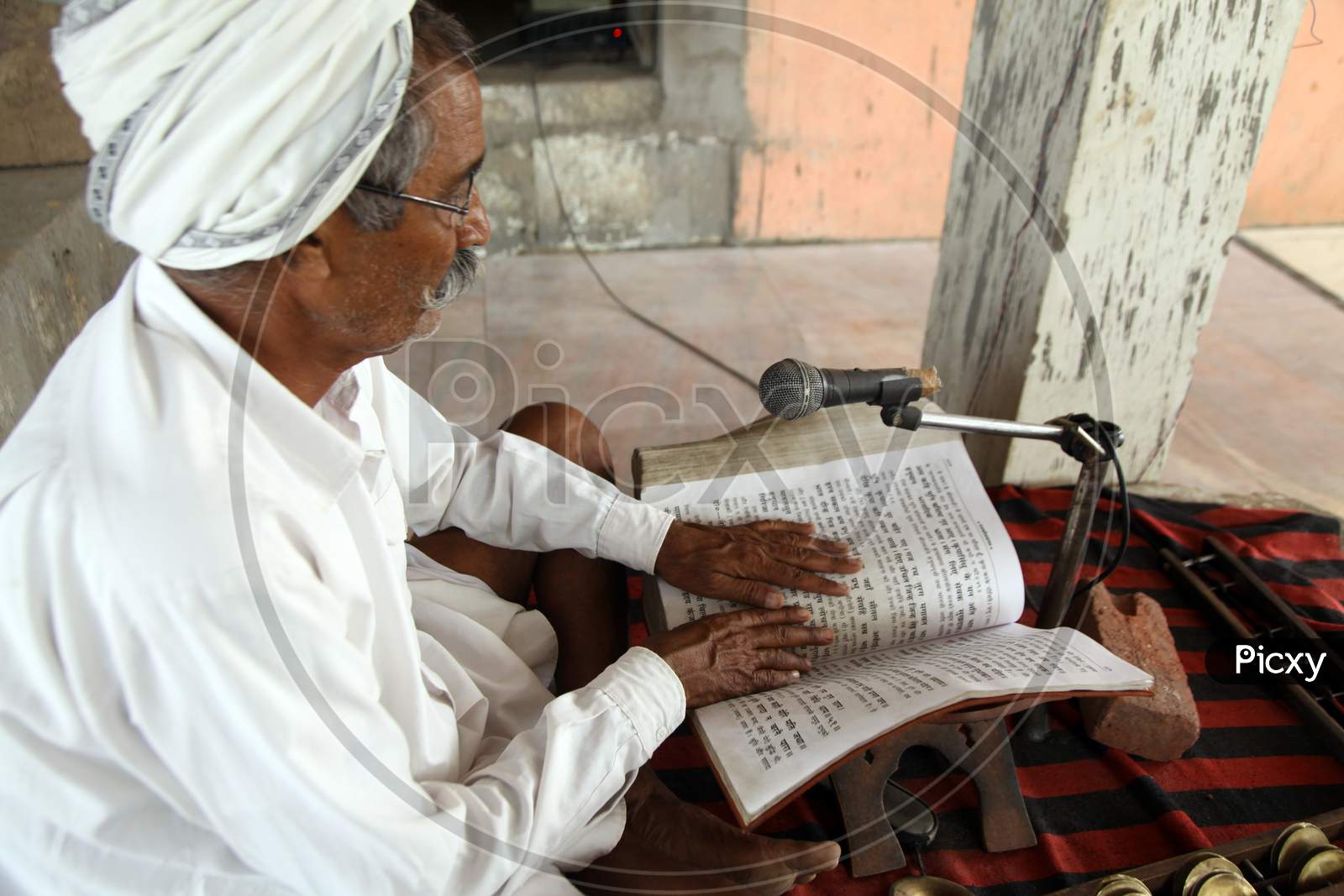 An Old Indian man reading a books