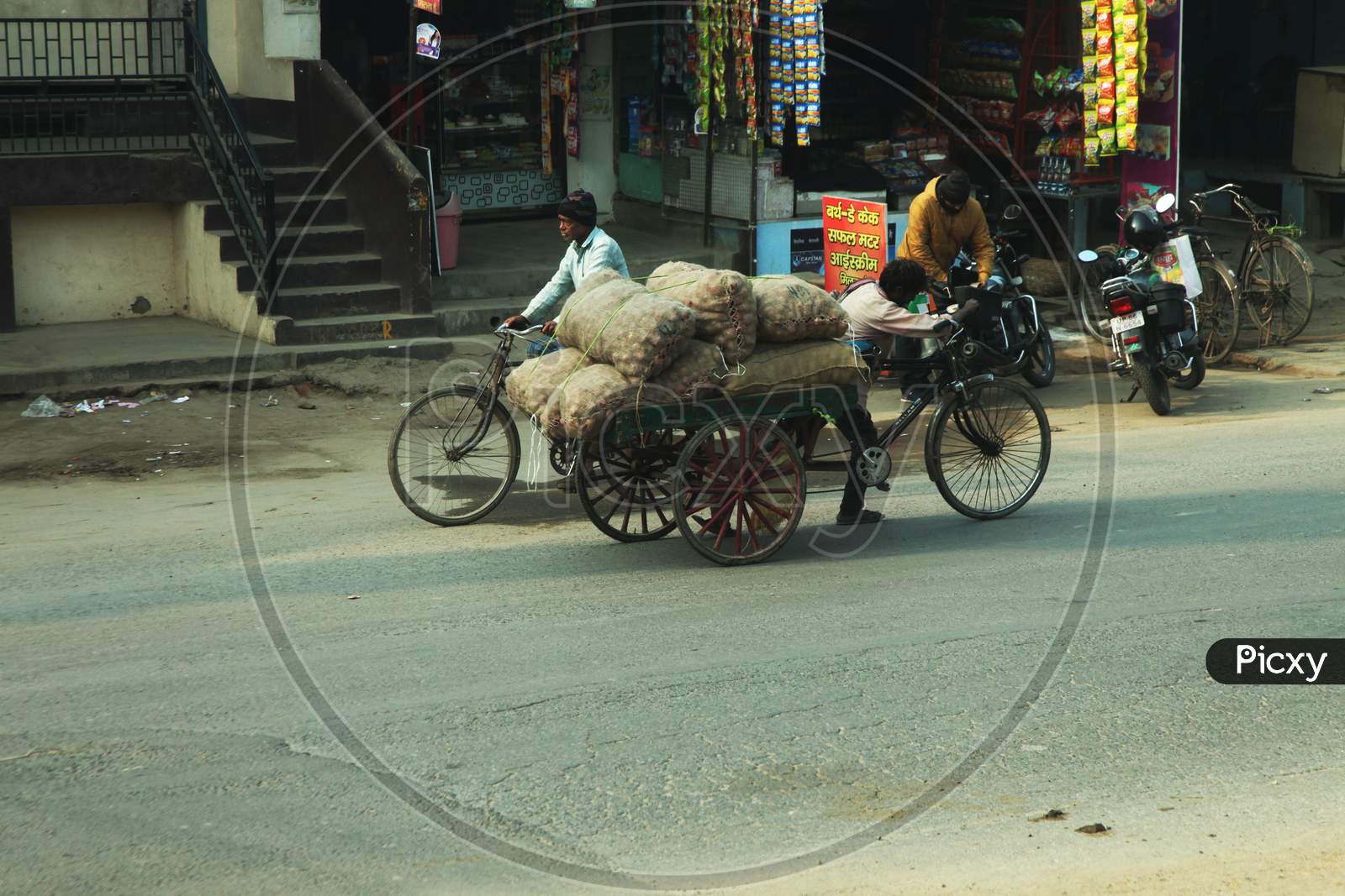 A Man with Rickshaw carrying onion Sacks