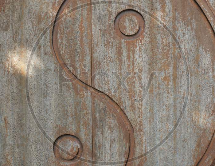 Yin-Yang Symbol Carved On Wooden Door