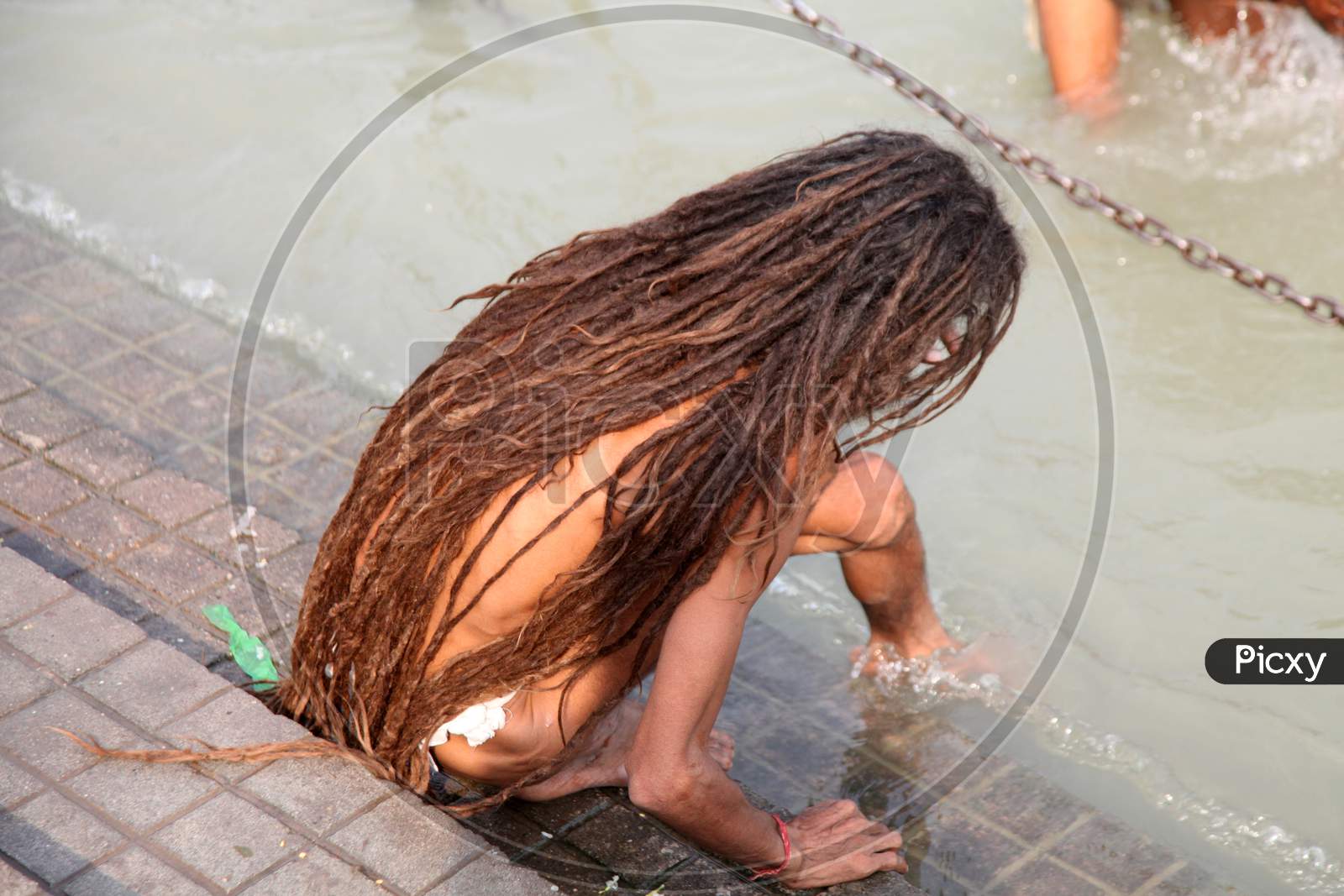 A Sadhu or Baba stepping to a river