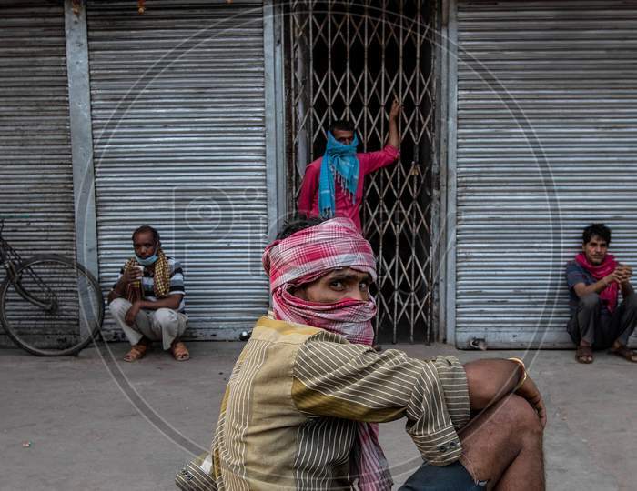 Migrant Daily Wage Workers Take Rest In Front Of The Closed Shops During Nationwide Lockdown To Curb The Spread Of Coronavirus,  On April 11, 2020 In New Delhi, India