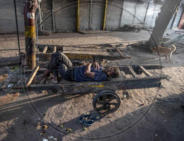 Migrant Daily Wage Workers Take Rest In Front Of The Closed Shops During Nationwide Lockdown To Curb The Spread Of Coronavirus,  On April 11, 2020 In New Delhi, India