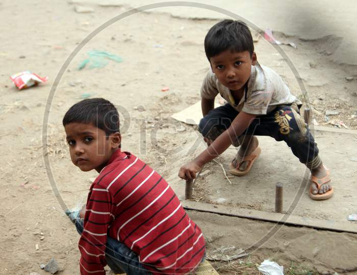 Photograph of an Indian Kids sitting on Ground