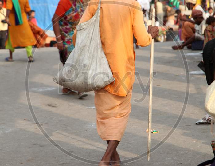 An Old Indian Hindu Sadhu or Baba walking on the Road