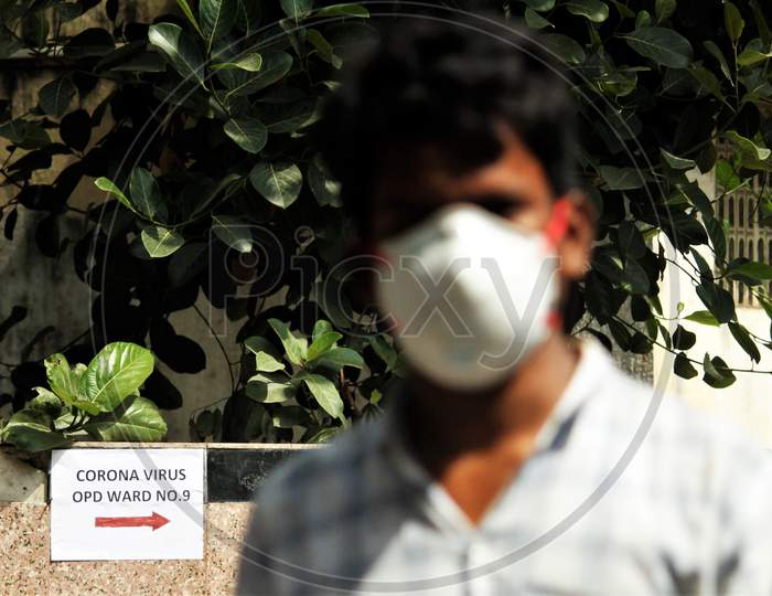 A man wearing a protective mask walk inside the premises of a hospital where a special ward has been set up for the coronavirus patients in Mumbai, India on March 5, 2020.