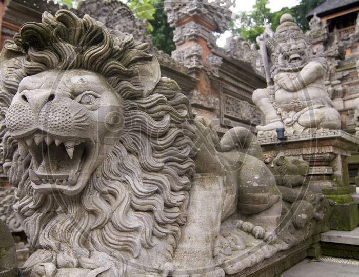 Lion Head Stone Statue At Pura Dalem Temple In Ubud