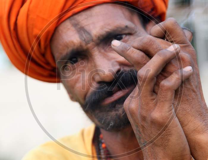 Portrait of an Indian Hindu Sadhu or Baba Smoking Chillam