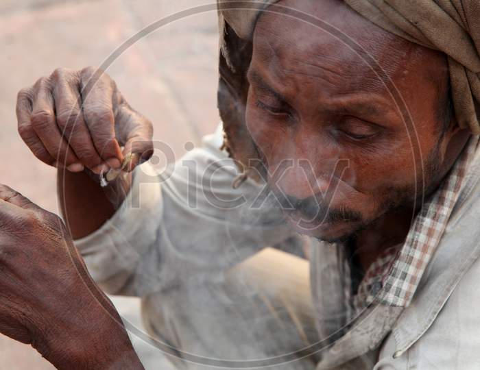 Close up shot of a Person smoking Beedi