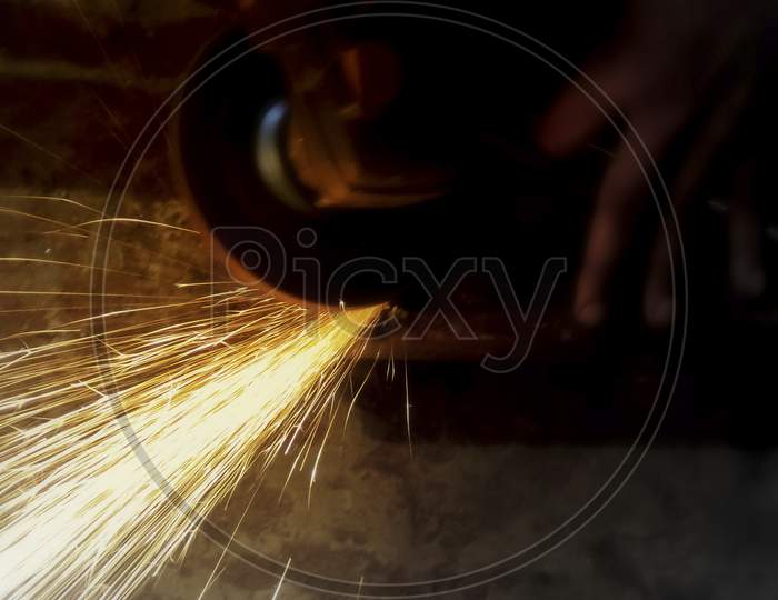 Sparks Flying While Machine Griding And Finishing Metal.Selective Focus.