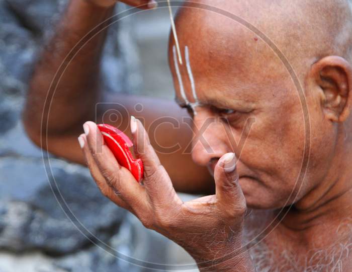 Portrait of a Middle-Aged Indian Man keeping namam