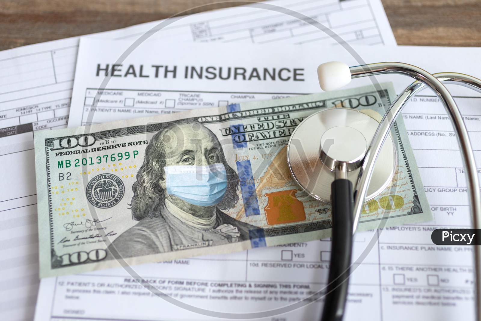 One hundred us dollar with face mask on insurance paper bill. Health care cost during coronavirus covid outbreak concept