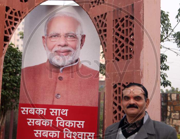 A Middle-Aged Indian Man with Shri Narendra Modi Poster