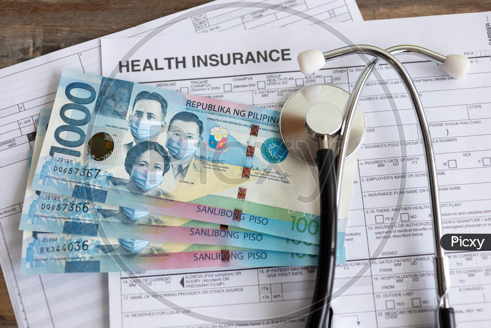 One thousand Philippines peso with face mask on insurance paper bill. Health care cost during coronavirus covid outbreak concept