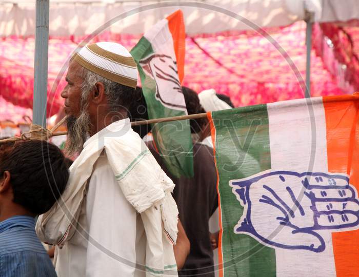 An Old Indian Man holding Congress Party Flag