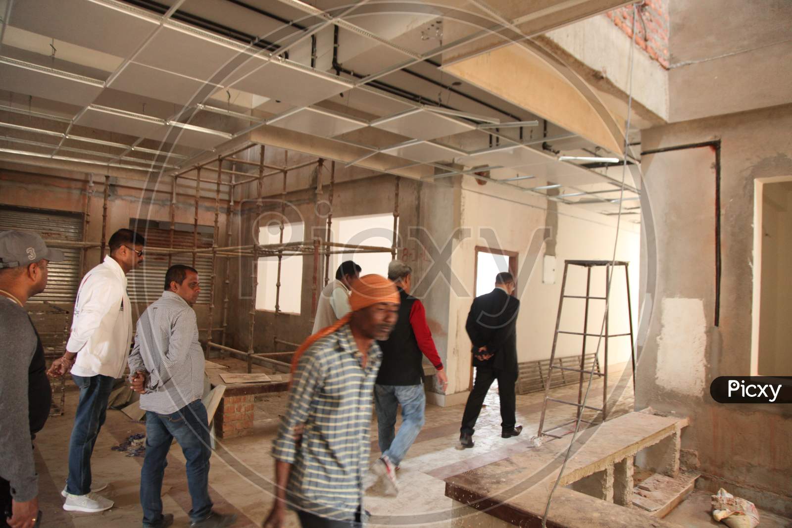 A building under construction with Workers at Work